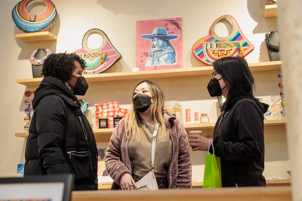 Christina Chan (center) talks with customers at the Seattle Restored Collective Marketplace.